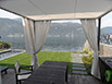 Gazebo realizzato con struttura in ferro verniciata e possilica con teli a scorrimento sulla parte superiore e teli a strappo sulla parte laterale.